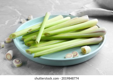 Plate With Fresh Lemongrass Stalks On Light Grey Marble Table, Closeup