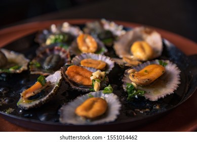 Plate of fresh limpets, grilled seashell with garlic butter