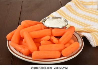 A Plate Of Fresh Organic Baby Carrots With Dip