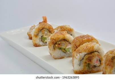 Plate Of Fresh Shrimp Tempura Sushi Roll On Plain Background