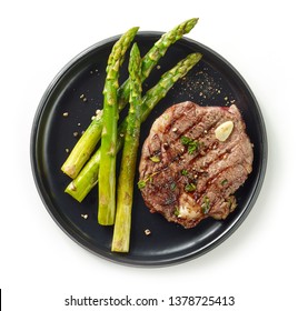 Plate Of Freshly Grilled Steak And Asparagus Isolated On White Background, Top View