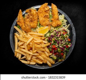 Plate Of Fried Chicken Tenders With Hot Chips And A Side Of Middle Eastern Fatoush Salad