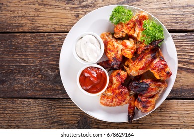 Plate Of Fried Chicken Wings On Wooden Table, Top View