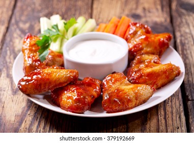 Plate Of Fried Chicken Wings With Sauce