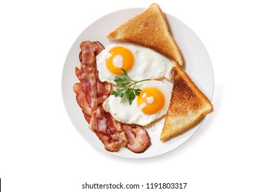 Plate Of Fried Eggs, Bacon And Toast Isolated On White Background, Top View