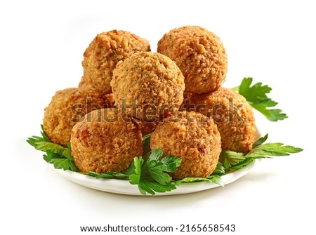 plate of fried falafel balls and parsley leaves isolated on white background