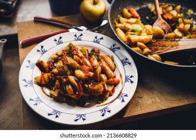 A Plate Of Fried Potatoes With Curry Ketchup.