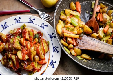 A Plate Of Fried Potatoes With Curry Ketchup.