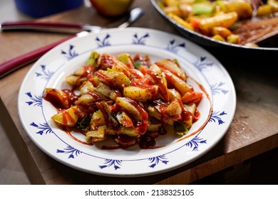 A Plate Of Fried Potatoes With Curry Ketchup.