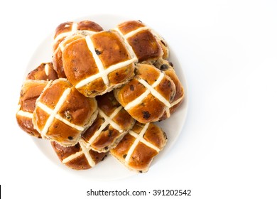 A plate full of freshly baked hot cross buns for the Easter holidays on an isolated white background. View from above looking down.