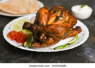 A Plate Of Full Thandoori Chicken , Arabian Spicy Food Tandoori Whole Chicken Bengaluru, India . Platter Served With Salads. Al Faham Charcoal Grilled Chicken .	
