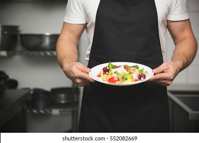 料理人の手で野菜サラダを作る写真素材 Shutterstock