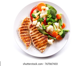 plate of grilled chicken with vegetables isolated on white background