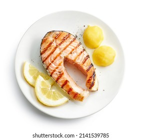 Plate Of Grilled Salmon Steak And Potato Isolated On White Background, Top View