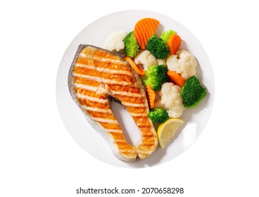 Plate Of Grilled Salmon Steak With Vegetables Isolated On White Background, Top View