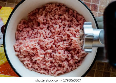 
A Plate Of Ground Turkey Meat And A Mincer