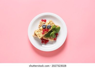 Plate With Healthy Cereal Bars And Berries On Color Background