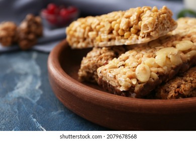Plate With Healthy Cereal Bars On Color Background