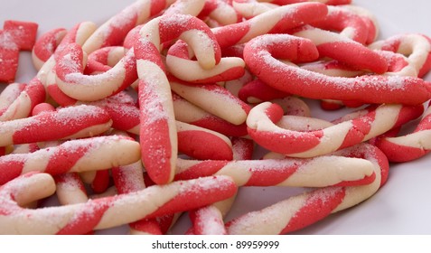 A Plate Of Homemade Candy Cane Cookies Sprinkled With Granulated Sugar.