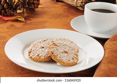 A Plate Of Iced Oatmeal Cookies With Coffee