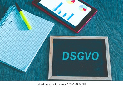 Plate with the inscription DSGVO (Datenschutzgrundverordnung) in English GDPR (General Data Protection Regulation) with a tablet and block for the introduction of the DSGVO in the EU