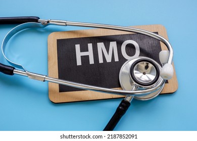 A Plate With An Inscription Health Maintenance Organization HMO And A Stethoscope.