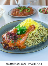 A Plate Of An Iranian Food With Marinated Chicken Garnished With Barberry And Parsley,a Bowl Of An Iranian Salad On A White Table.
Lima Bean, Dill, Saffron.