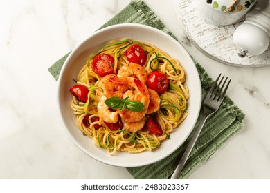 Plate of italian pasta. prawn, tomato and courgette, or zucchini, spaghetti. Top view, white marble table. - Powered by Shutterstock