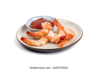 A Plate Of Large Cooked Peeled Shrimp With Seafood Sauce Isolated On White