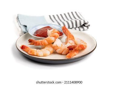 A Plate Of Large Cooked Peeled Shrimp With Seafood Cocktail Sauce Isolated On White