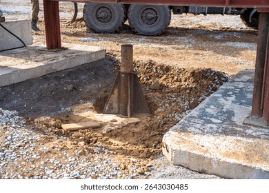 Plate load test in progress with heavy weight applying static pressure on soil. Geotechnical procedure to assess ground settlement and load-bearing capacity. High quality photo