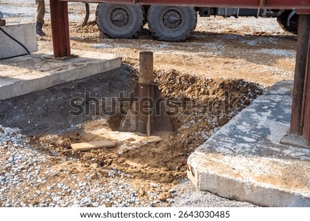 Plate load test in progress with heavy weight applying static pressure on soil. Geotechnical procedure to assess ground settlement and load-bearing capacity. High quality photo