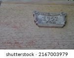 Plate made of concrete on the facade of the house with the year of construction 1957