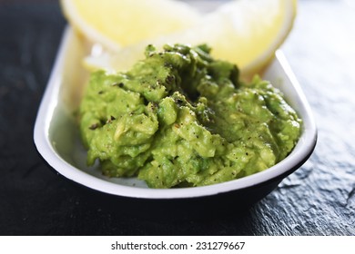 Plate With Mashed Avocado And Lemon