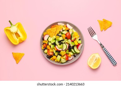 Plate With Mexican Vegetable Salad, Nachos, Bell Pepper And Lemon On Pink Background