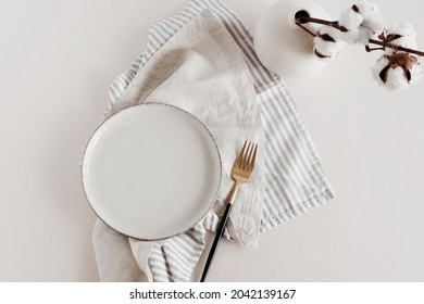 Plate mockup, empty modern minimal table place setting neutral beige color top view.Flowers cotton branch.  Space for text or menu .Business food brand template. Scandinavian style tableware.
