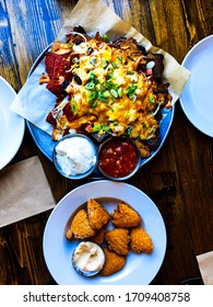 A Plate Of Nachos With Fried Macaroni And Cheese Bites.