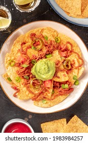 A Plate Of Nachos, Mexican Tortilla Chips, Overhead Shot On A Black Background