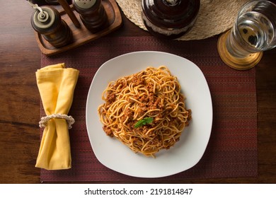 Plate Of Noodles Bolognese Spaghetti Pasta Comfort Food Wooden Dining Table