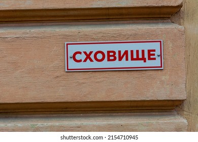 A plate on the wall of a house with the inscription SHELTER in a Ukrainian city. The war between Russia and Ukraine, grief, a sign of a bomb shelter for the townspeople.