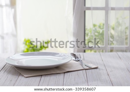 Plate on wooden background
