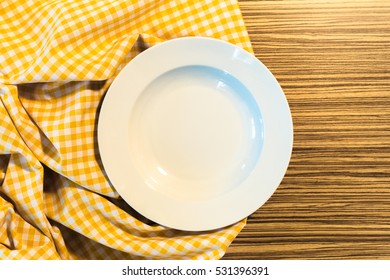 The Plate On Yellow Checkered Table Cloth