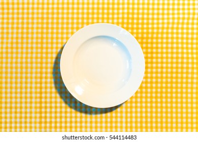 The Plate On Yellow Checkered Table Cloth