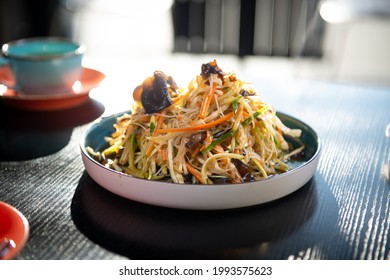 Plate With Oriental Food On The Edge Of The Table In The Restaurant