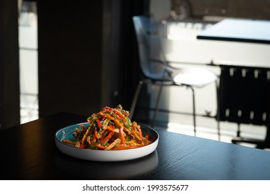 Plate With Oriental Food On The Edge Of The Table In The Restaurant