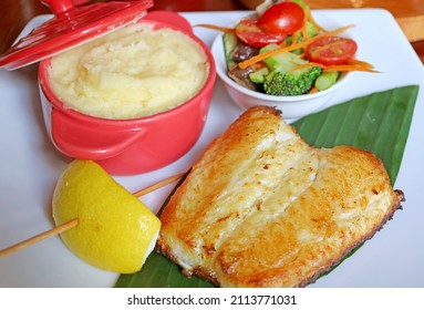 Plate Of Pan Seared Sea Bass With Salad And Mashed Potatoes