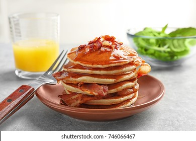 Plate With Pancakes And Bacon On Table