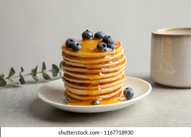 Plate with pancakes and berries on table