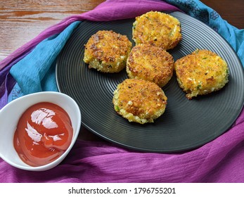 A Plate With Paneer Cutlet, A Breaded Crispy Patty With Paneer Cheese And Potato.