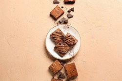 Plate With Pieces Of Tasty Chocolate Brownie On Beige Background
